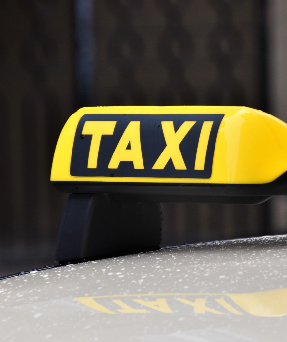 yellow and black taxi sign